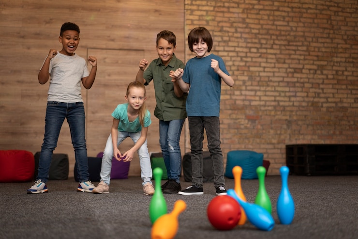 Free Photo full shot happy kids playing bowling