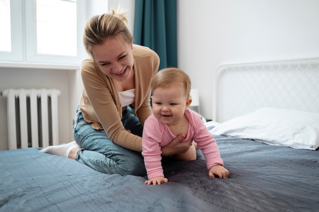 Full shot happy mother holding baby