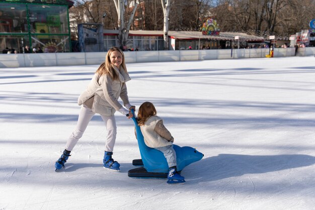 Full shot happy mother with girl at rink