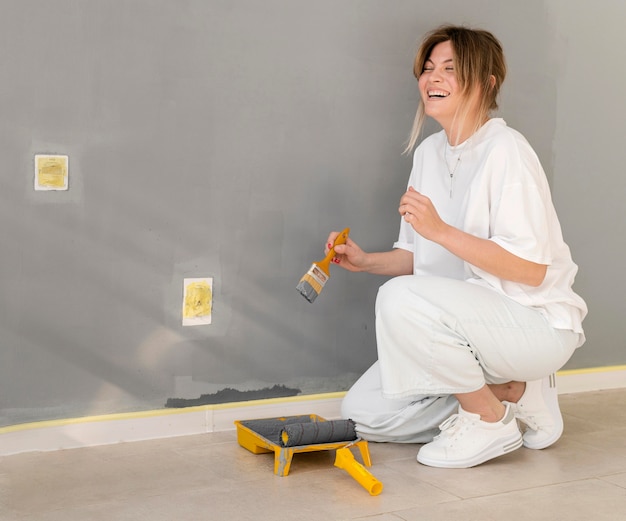 Full shot happy woman holding brush