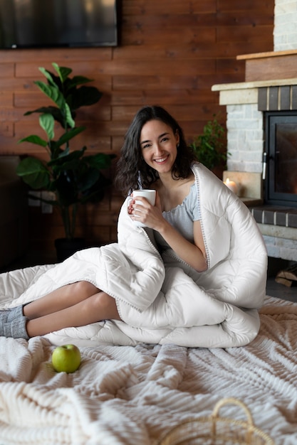 Full shot happy woman holding hot drink