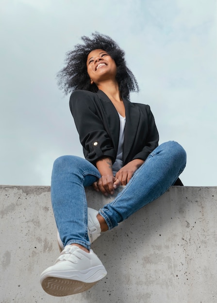 Free photo full shot happy woman posing outdoors