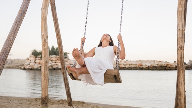 Full shot happy woman in swing