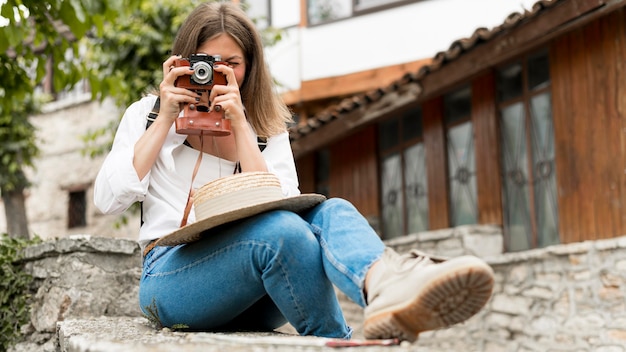 Free photo full shot happy woman taking photos