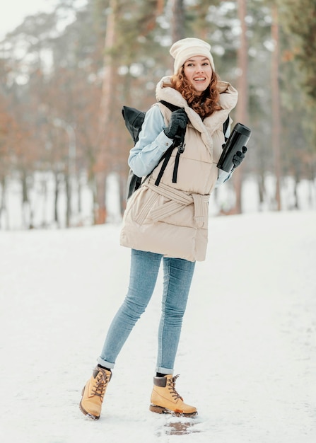 Full shot happy woman with thermos