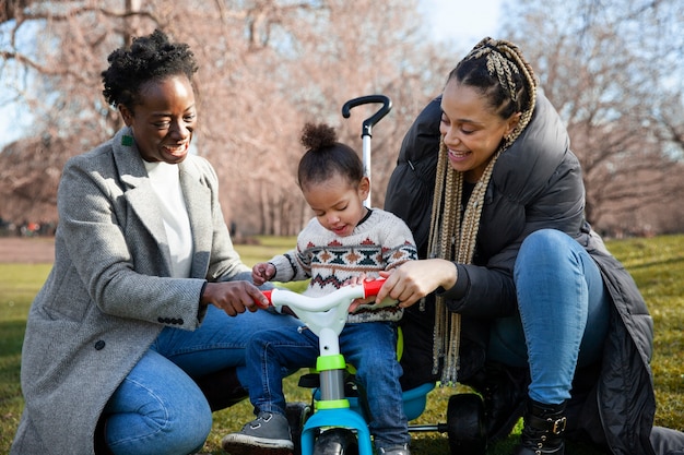 Full shot happy women and child outdoors