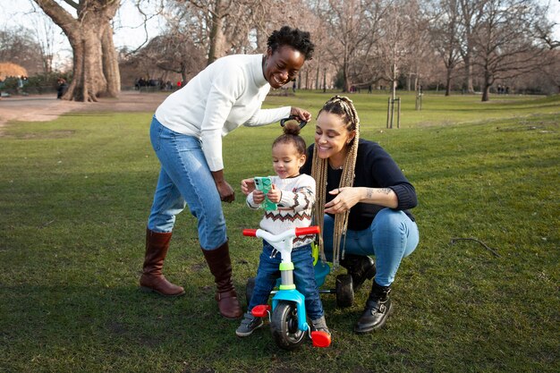 Full shot happy women and girl in park