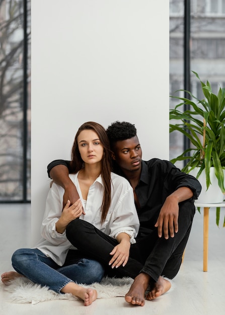 Full shot interracial couple posing
