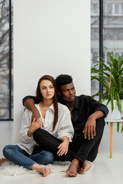 Full shot interracial couple sitting