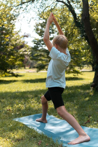 Full shot kid doing yoga