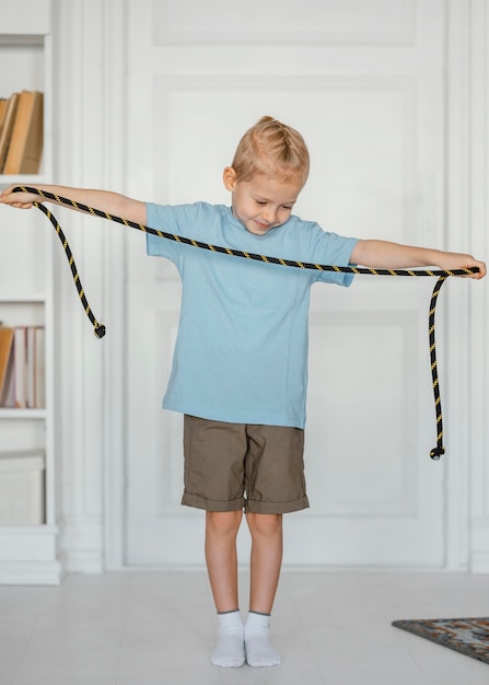 Full shot kid holding jumping rope