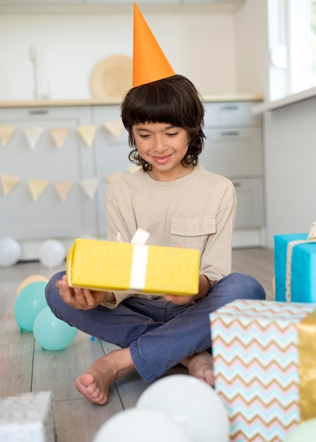 Free photo full shot kid holding present