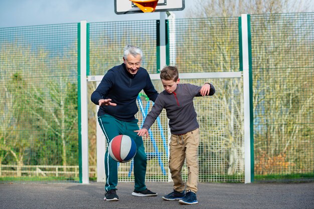 Full shot kid and man playing together