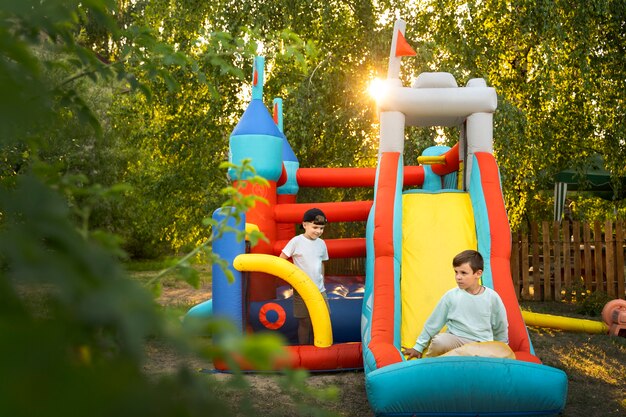 Full shot kid playing in bounce house