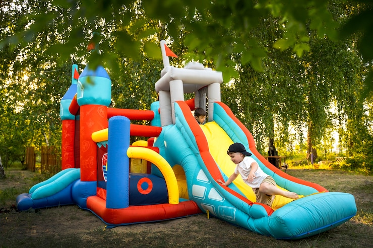 Free Photo full shot kid playing in bounce house