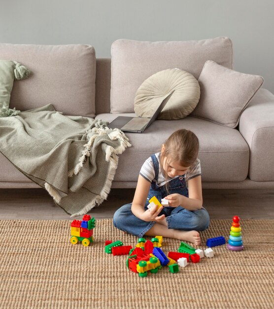 Full shot kid playing on floor