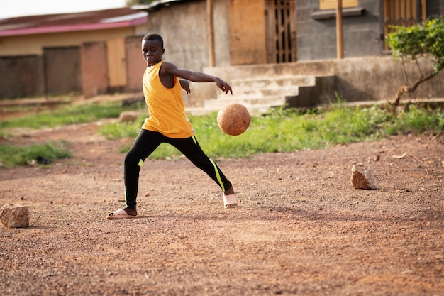 Free photo full shot kid playing with ball