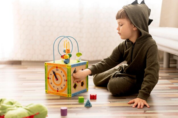 Full shot kid playing with box