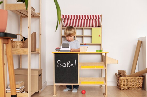 Full shot kid playing with wooden toys