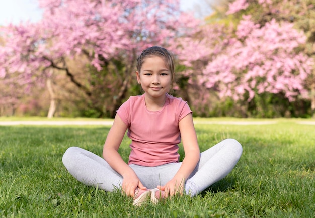 Free photo full shot kid sitting on grass