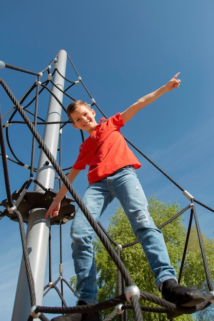 Full shot kid standing on rope