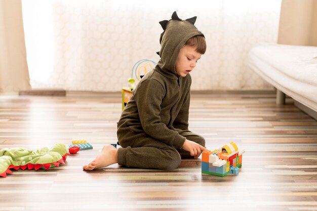full shot kid wearing dragon costume