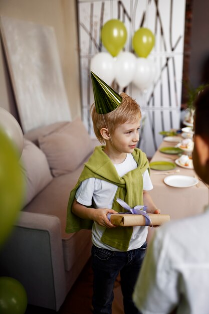 Full shot kid wearing party hat