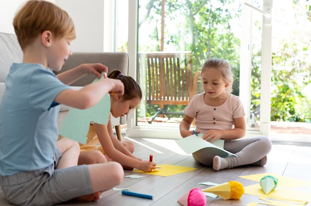 full shot kids being creative with paper