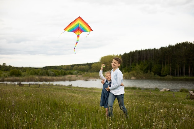 Full shot kids flying a kite