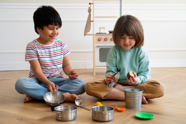 Full shot kids playing on floor