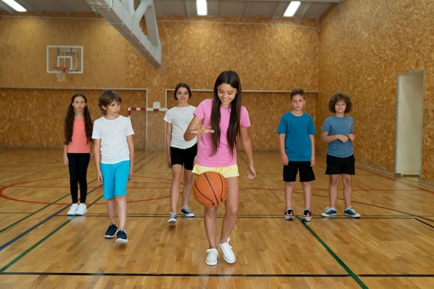 Full shot kids playing at gym