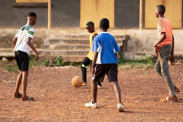 Full shot kids playing with ball outdoors