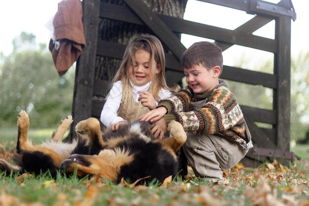 Full shot kids playing with dog