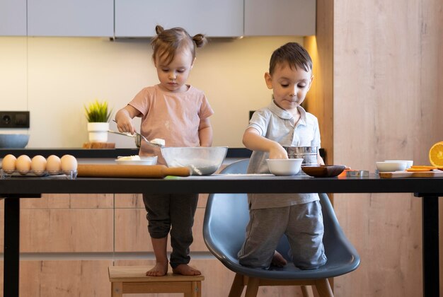 一緒に食事を準備するフルショットの子供たち