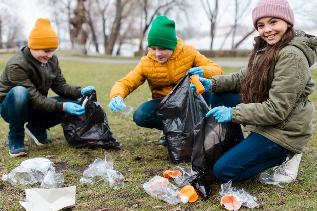 Full shot of kids recycling on ground