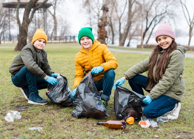 Full shot of kids recycling on ground