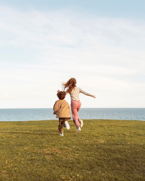 Full shot kids running outdoors