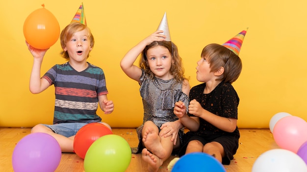 Full shot kids sitting on floor