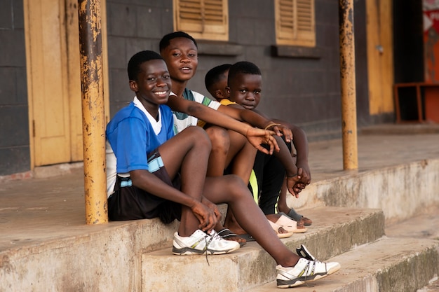 Full shot kids sitting on stairs