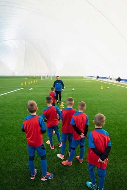 Free photo full shot kids training on field