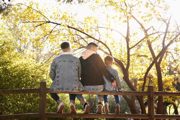 Full shot lgbt family sitting outdoors