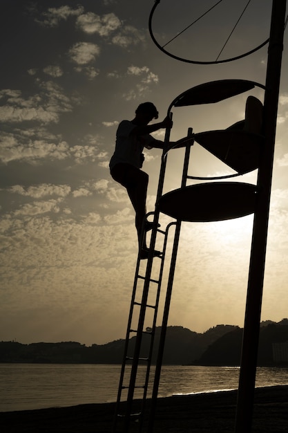 Full shot lifeguard climbing ladder