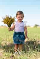 Free photo full shot of a little girls holding a bouquet