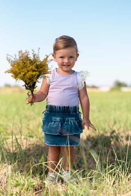 Full shot of a little girls holding a bouquet