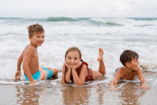 Full shot little kids having fun at the beach