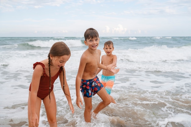 Full shot little kids having fun at the beach