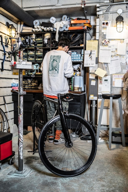 Full shot man in bike shop