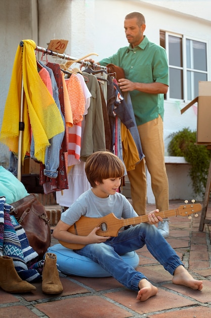 Full shot man and boy at garage sale