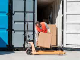 Free photo full shot man carrying box