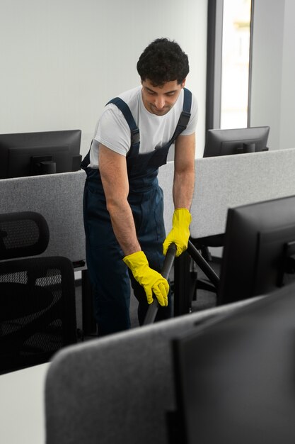 Full shot man cleaning indoors
